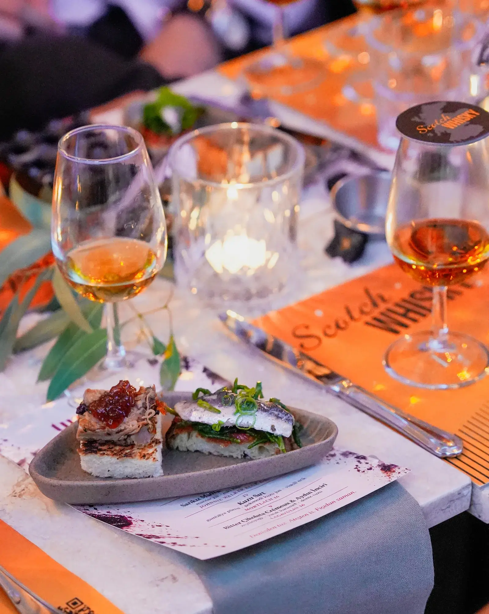 A dinner table set with a menu card and a plate