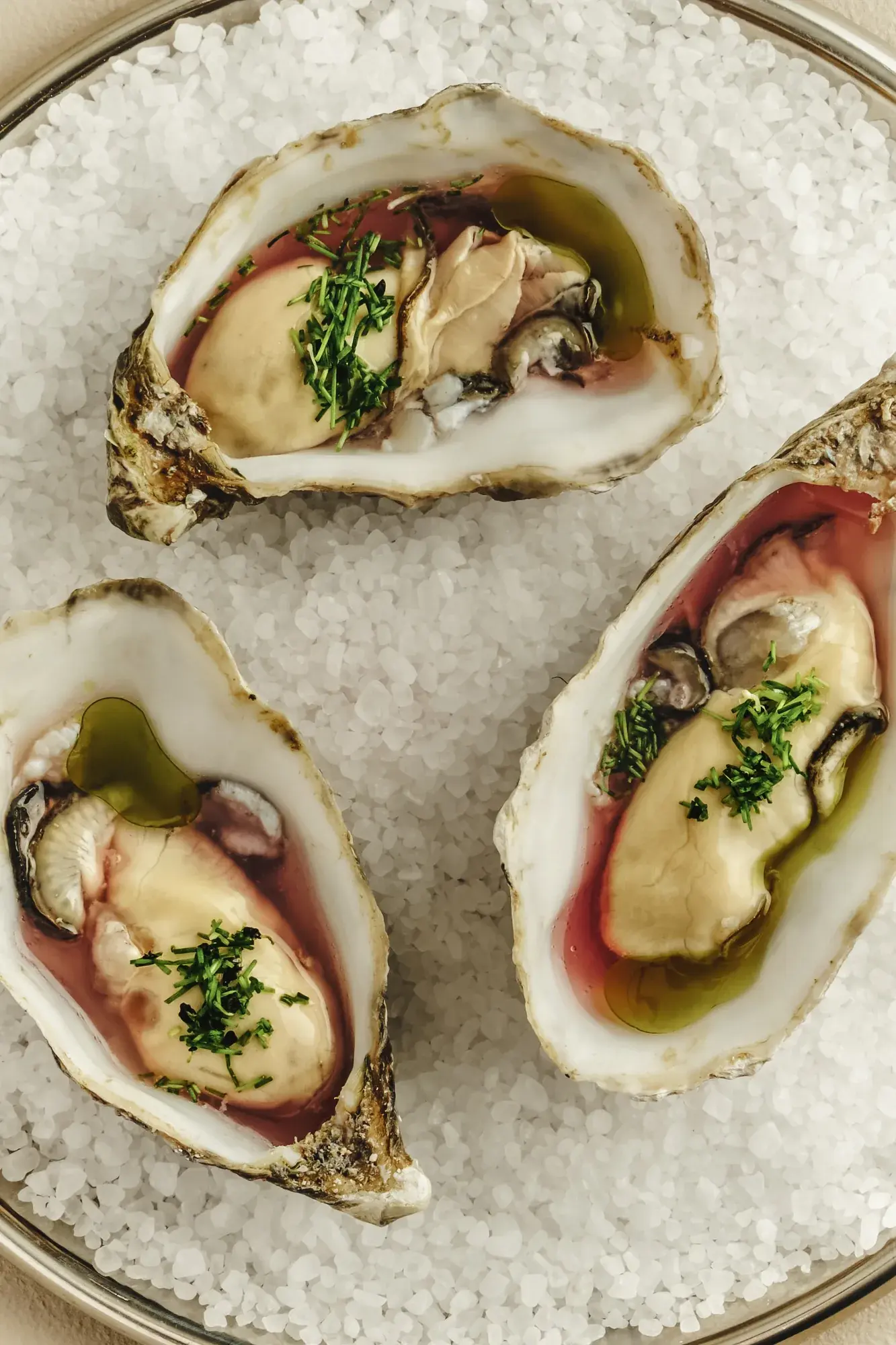 Oysters on salt with chives and green oil