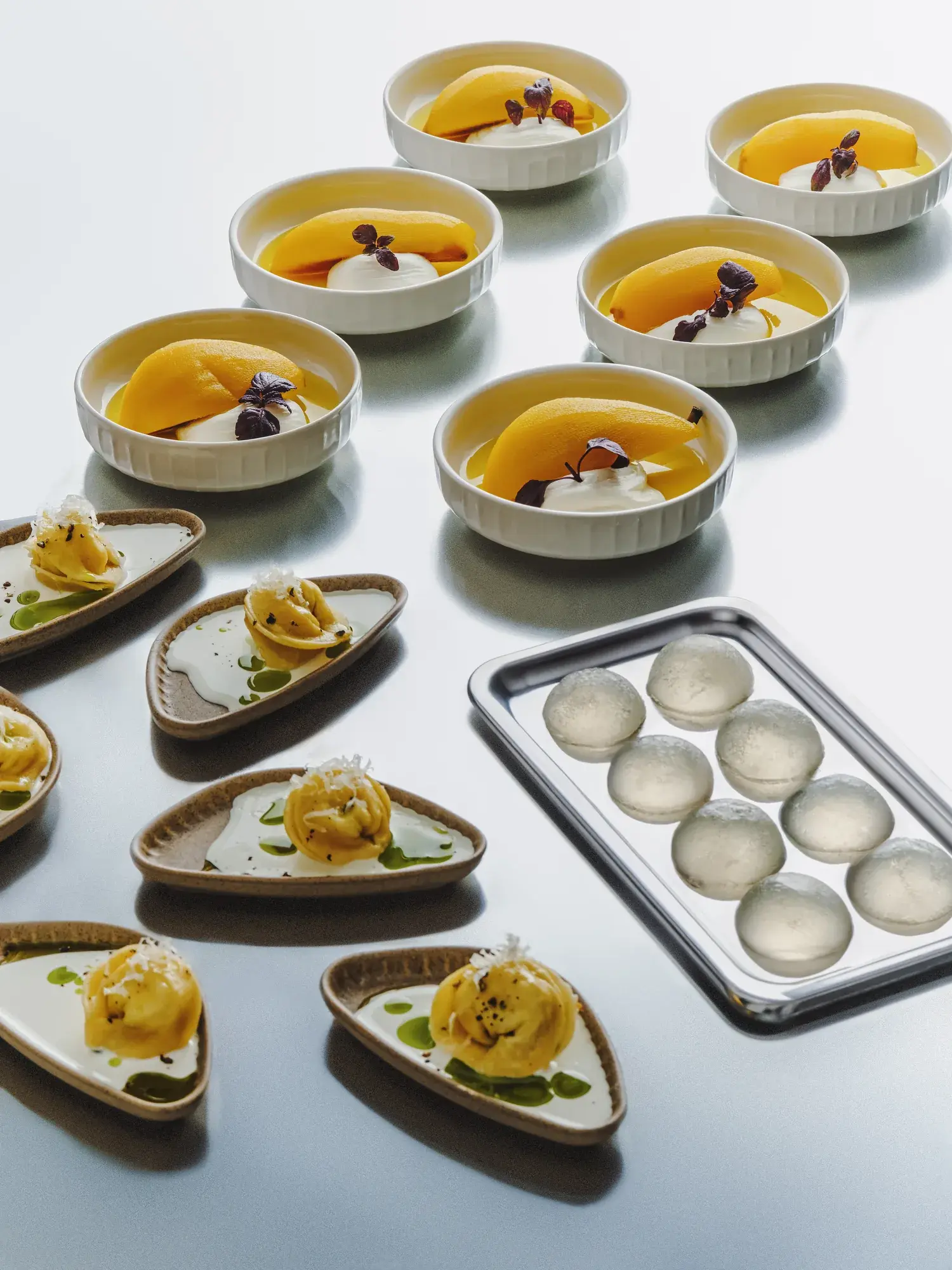 Peach bowls, tortellini and gelée spheres