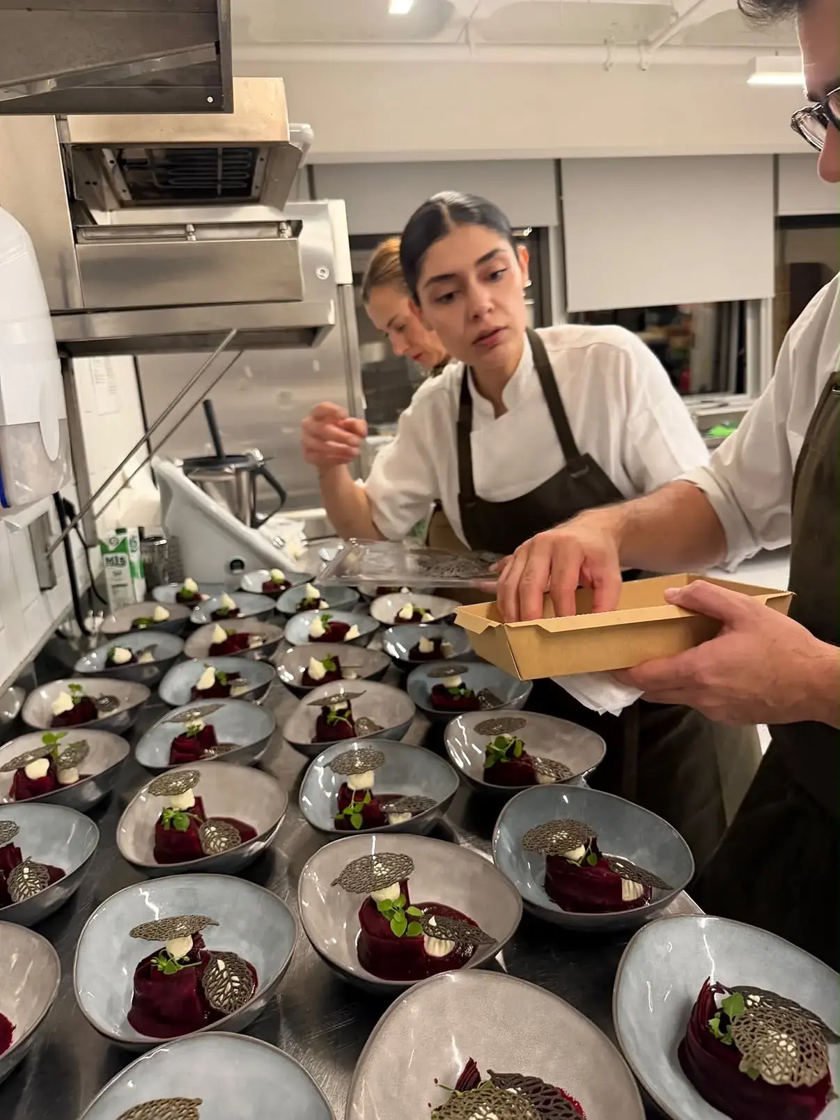 Pınar İshakoğlu and her team finishing beetroot plates before service
